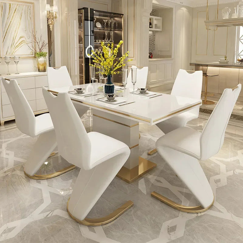 Modern dining room with a white table and chairs in a stylish interior.