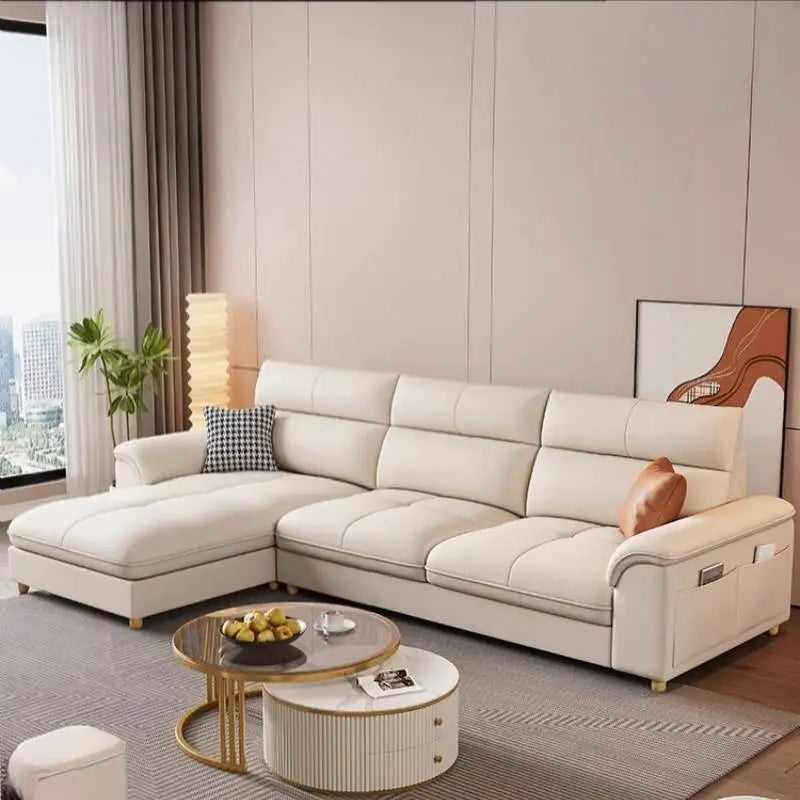 Modern living room with a beige sectional sofa, coffee table, and decorative items.