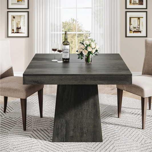A square-shaped, gray wood grain finish dining table with a sturdy pedestal base, set in a room with two chairs, prepared for a meal with dishes and silverware.