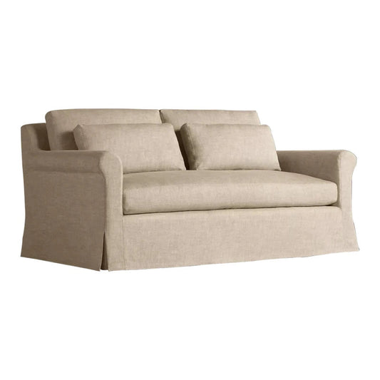Beige sofa with three cushions on a white background