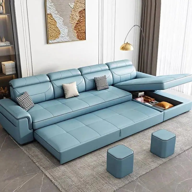 Blue sectional sofa in a living room setting with ottomans and decor.