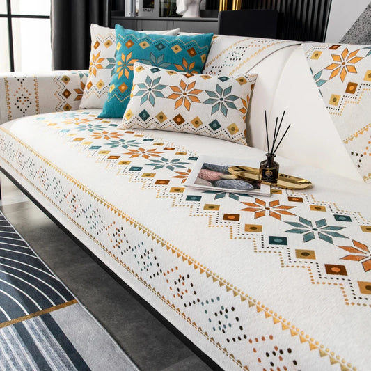 Decorative sofa with patterned cover and pillows in a living room setting