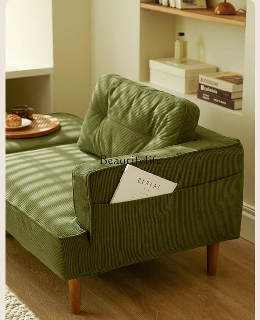 Green armchair with a cushion and a book on a wooden floor, with 'Beautiful life' branding.