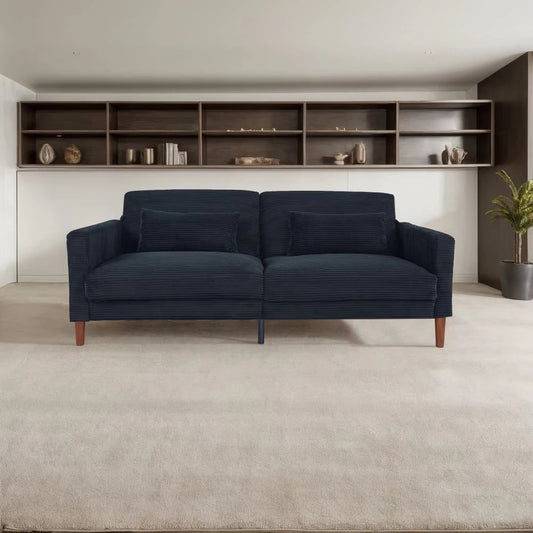 Blue sofa in a modern living room with a bookshelf in the background.
