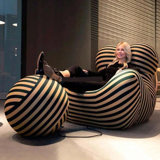 Woman sitting on a striped bean bag chair in a modern interior setting.