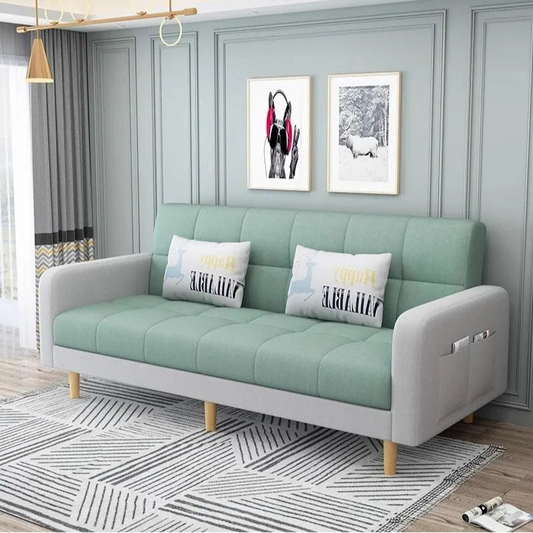 Light green sofa with white cushions in a living room setting