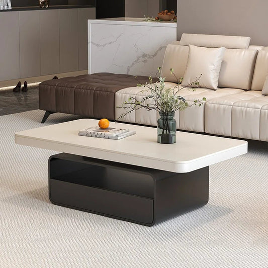 Modern living room with a coffee table, sofa, and decorative items.