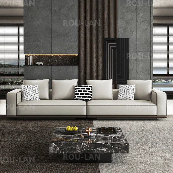 Modern living room with a gray sofa and marble coffee table, featuring the brand 'ROU-LAN'.