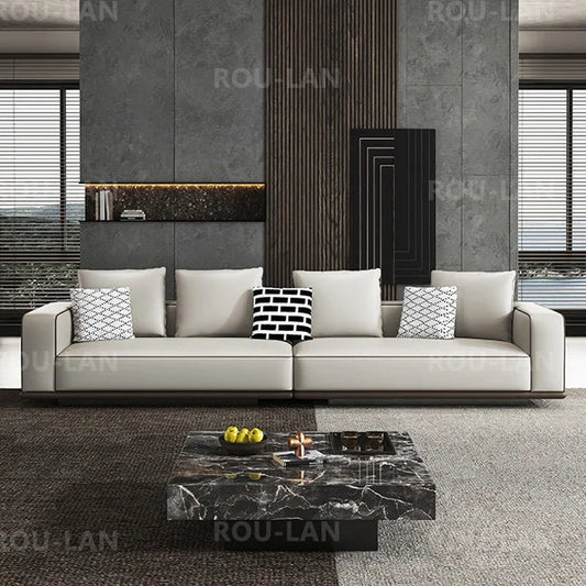 Modern living room with a gray sofa and marble coffee table, featuring the brand 'ROU-LAN'.