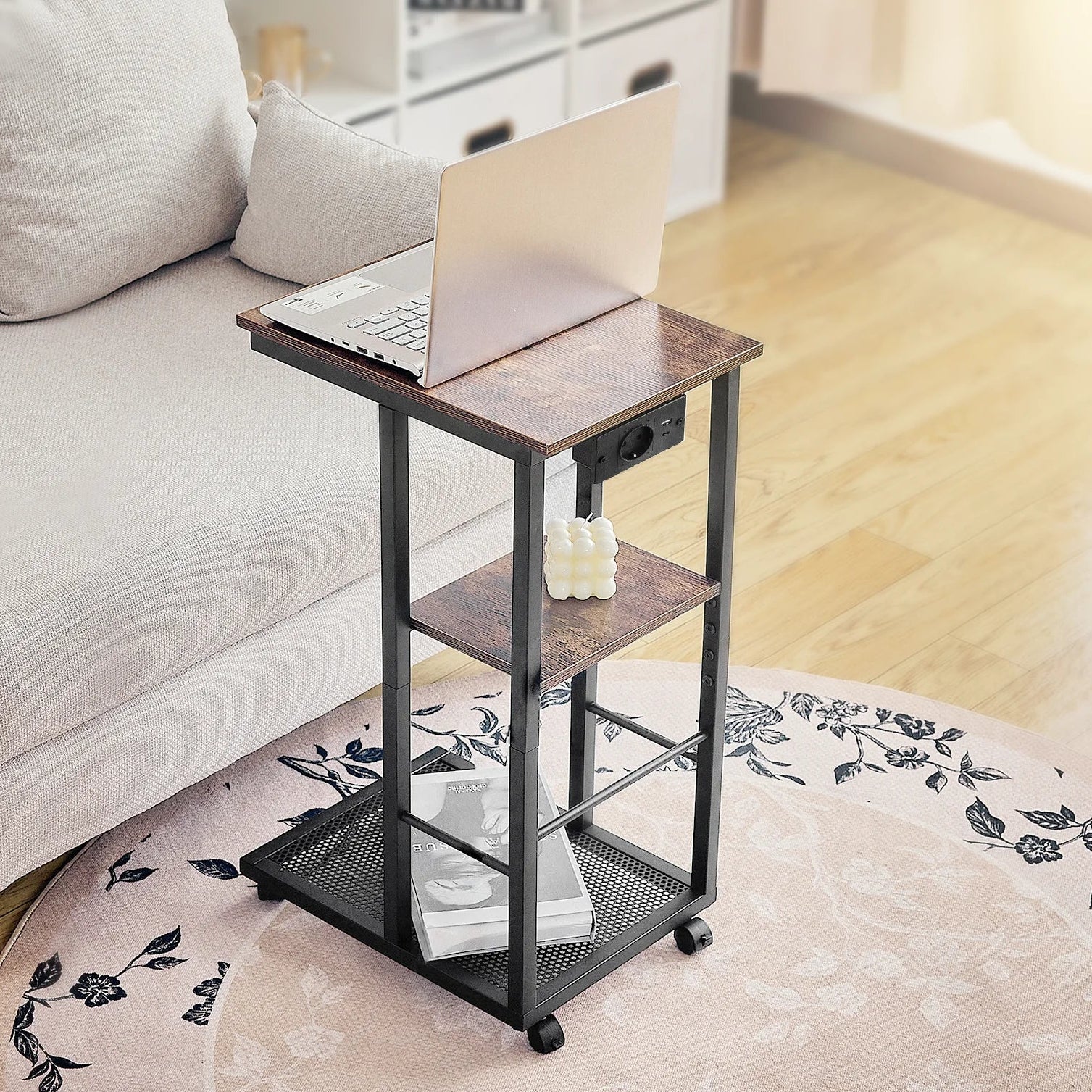Small rolling table with a laptop on top in a living room setting