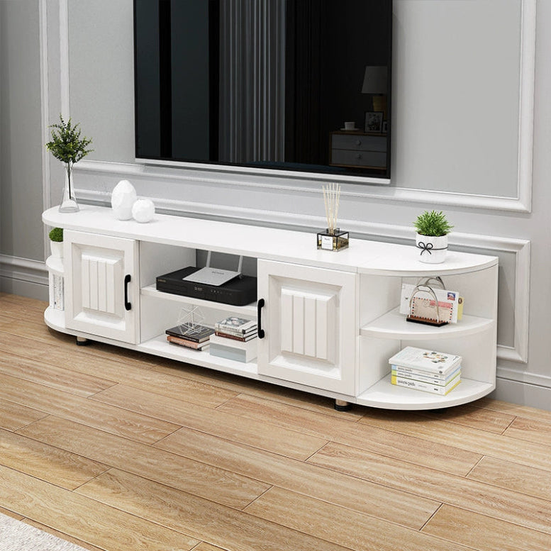White TV stand with decorative items in a room with a television mounted on the wall.