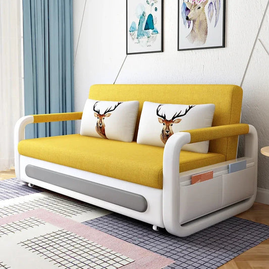 Yellow and white sofa with deer-patterned cushions in a room with decor elements.